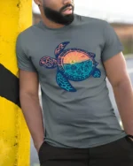 Sea Turtle Sunset Ocean Life Graphic Tee Coastal Aesthetic - model wearing grey tee, leaning on column