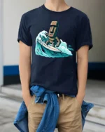 Funny Surfing Moai Statue Graphic Tee Retro Beach Humor Style - model wearing navy tee with hands in pockets