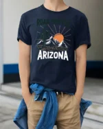 Arizona Desert Road Trip Graphic Tee Retro Travel Adventure Style - model wearing navy tee with hands in pockets