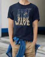 Surf Vibe Ride Wave Graphic Tee Retro Beach Adventure Style - model wearing navy tee with hands in pockets