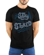 Stay Stoked Surf Graphic Tee Beach Lover Positive Vibes - model wearing black tee with hands behind back