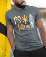 Aloha Tropical Surf Vibes Graphic Tee Hawaiian Beach Style - model wearing grey tee, leaning on column