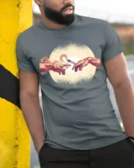 Funny Creation Of Adam Coffee Graphic Tee Art Parody Style - model wearing grey tee, leaning on column