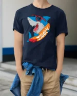 Funny Surfing Shark Graphic Tee Cool Summer Ocean Style - model wearing navy tee with hands in pockets