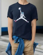 Astronaut Jump Graphic Tee Space Basketball Style Art - model wearing navy tee with hands in pockets