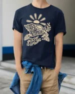 Ocean Is Calling Sea Turtle Graphic Tee Coastal Travel Mood - model wearing navy tee with hands in pockets