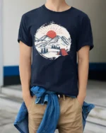 Mountain Camping Sunset Graphic Tee Outdoor Adventure Style - model wearing navy tee with hands in pockets