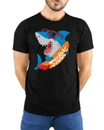 Funny Surfing Shark Graphic Tee Cool Summer Ocean Style - model wearing black tee with hands behind back