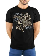 Enjoy The Ride Dolphin Graphic Tee Ocean Positive Style - model wearing black tee with hands behind back