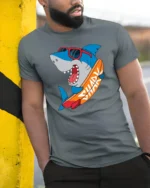Funny Surfing Shark Graphic Tee Cool Summer Ocean Style - model wearing grey tee, leaning on column