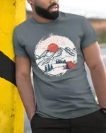Mountain Camping Sunset Graphic Tee Outdoor Adventure Style - model wearing grey tee, leaning on column