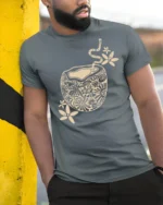 Artistic Coffee Cup Graphic Tee Cozy Aesthetic Style Design - model wearing grey tee, leaning on column