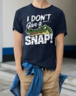 Funny I Dont Give A Snap Crocodile Graphic Humor Tshirt Tee - model wearing navy tee with hands in pockets
