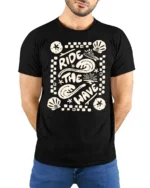 Ride The Wave Graphic Tee Retro Beach Surf Style Tshirt - model wearing black tee with hands behind back