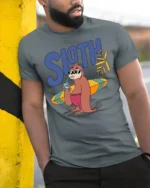 Funny Sloth Surfing Graphic Tee Chill Beach Vibes Tshirt - model wearing grey tee, leaning on column