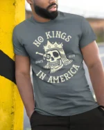 No Kings In America Skull Graphic Tee Patriotic Vintage Tshirt - model wearing grey tee, leaning on column
