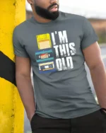 Im This Old Retro Cassette Floppy Disk Graphic Tee Tshirt - model wearing grey tee, leaning on column