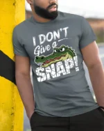 Funny I Dont Give A Snap Crocodile Graphic Humor Tshirt Tee - model wearing grey tee, leaning on column