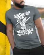 Simple Life Tropical Hummingbird Graphic Tee Freedom Vibes - model wearing grey tee, leaning on column