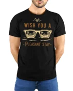We Wish You A Pleasant Stay Vacation Vibes Graphic Tee - model wearing black tee with hands behind back