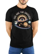You Are The Universe Cosmic Eye Planets Graphic Tee - model wearing black tee with hands behind back