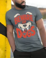 Beware Of The Dogs Funny Guard Dog Graphic Tee Bold Style - model wearing grey tee, leaning on column