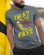 Im A7 And Im Fast Snail Graphic Tee Funny Speed Humor Tshirt - model wearing grey tee, leaning on column