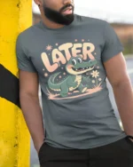 Later Alligator Cute Cartoon Vintage Vibes Tshirt - model wearing grey tee, leaning on column