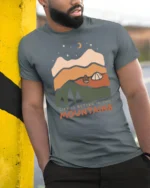 Life Is Better In The Mountains Vintage Nature Graphic Tee - model wearing grey tee, leaning on column