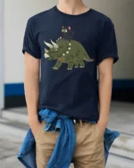 Funny Cat Riding Dinosaur Cute Cartoon Graphic Tee Tshirt - model wearing navy tee with hands in pockets