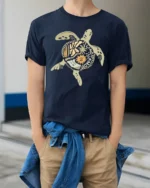 Long Island Sea Turtle Boho Ocean Art Graphic Tee Coastal Tshirt - model wearing navy tee with hands in pockets
