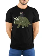 Funny Cat Riding Dinosaur Cute Cartoon Graphic Tee Tshirt - model wearing black tee with hands behind back