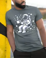 Pixel Astronaut Coffee Space Retro Gamer Graphic Tee Tshirt - model wearing grey tee, leaning on column