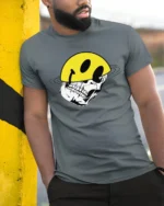 Edgy Skull With Smile Helmet Graphic Tee Tshirt Urban Vibes - model wearing grey tee, leaning on column