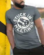 Stuck In Meetings Funny Office Humor Melting Face Tee Tshirt - model wearing grey tee, leaning on column