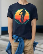 Retro Mountain Biking Sunset Graphic T Shirt Adventure Tee - model wearing navy tee with hands in pockets