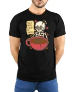 Only Need A Cup Of Coffee Skeleton Graphic T Shirt Funny Tee - model wearing black tee with hands behind back