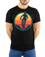 Retro Mountain Biking Sunset Graphic T Shirt Adventure Tee - model wearing black tee with hands behind back