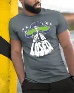 Get In Loser Alien UFO Graphic T Shirt Funny Space Tee - model wearing grey tee, leaning on column