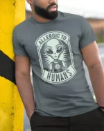 Allergic To Humans Alien Graphic T Shirt Funny UFO Tee - model wearing grey tee, leaning on column