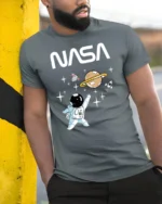 Cute Astronaut Space Adventure Graphic Tee Funny NASA Tshirt - model wearing grey tee, leaning on column