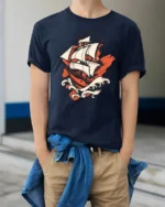 Vintage Sailing Ship Ocean Adventure Bold Graphic T Shirt - model wearing navy tee with hands in pockets