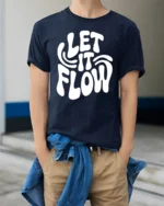 Let It Flow Positive Vibes Retro Typography Graphic T Shirt - model wearing navy tee with hands in pockets