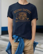 Ocean Coffee Beach Vibes Cute Coastal Lover Graphic T Shirt - model wearing navy tee with hands in pockets