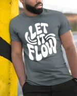 Let It Flow Positive Vibes Retro Typography Graphic T Shirt - model wearing grey tee, leaning on column