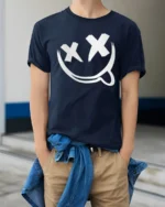 Edgy Smiley Face X Eyes Tongue Out Cool Graphic Tee - model wearing navy tee with hands in pockets