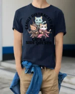 Easily Distracted By Cats And Side Quests Funny Gamer T Shirt - model wearing navy tee with hands in pockets