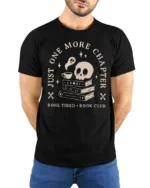 Just One More Chapter Bone Tired Book Club Funny T Shirt - model wearing black tee with hands behind back