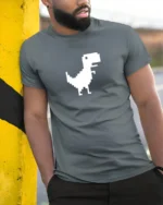 Pixel Dinosaur Offline Chrome Dino Funny Retro Gaming T Shirt - model wearing grey tee, leaning on column