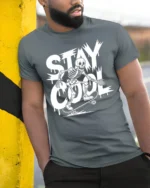 Stay Cool Skeleton Skateboard Funny Street Style Graphic T Shirt - model wearing grey tee, leaning on column